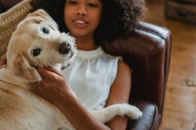 woman lying with purebred dog